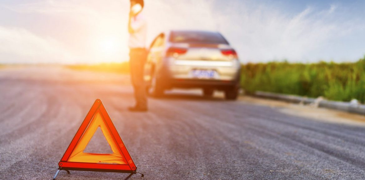 Image of a woman with a flat tire.